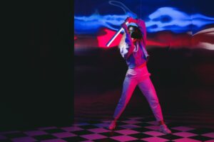 a woman with a stick and a virtual reality headset