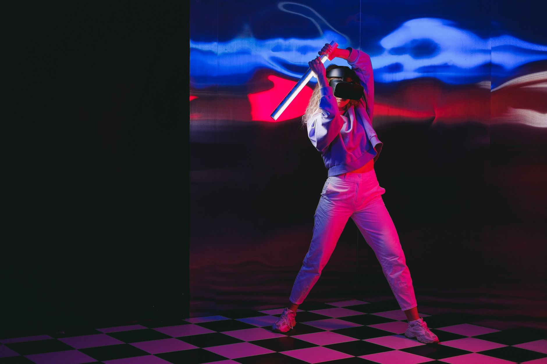 a woman with a stick and a virtual reality headset